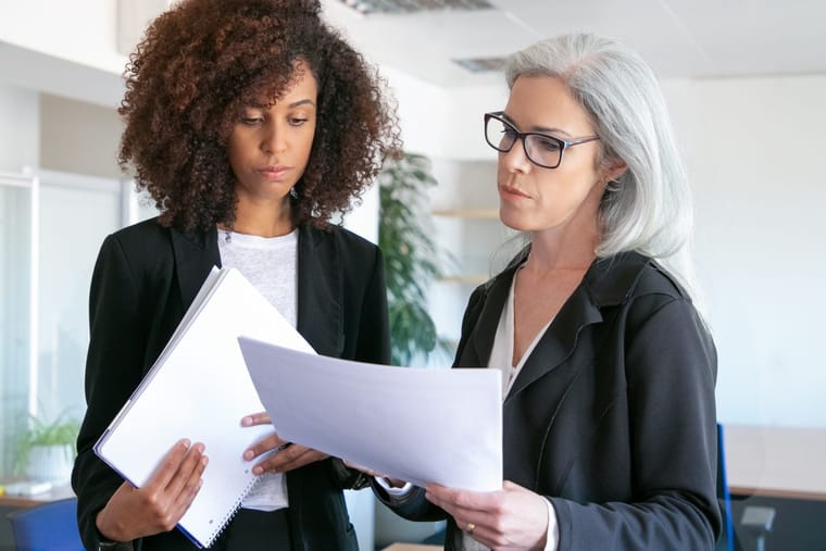 confident-focused-female-boss-glasses-reading-report-african-american-attractive-successful-young-businesswoman-holding-documentation-manager-teamwork-business-management-concept-2048x1365.jpg