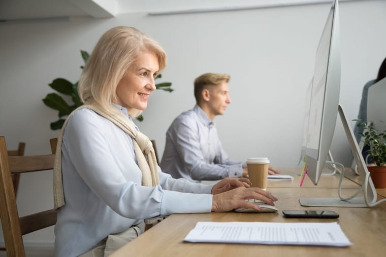smiling-aged-businesswoman-using-computer-working-online-coworking-office-2048x1365.jpg